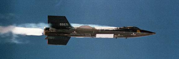 X-15 #2 launches away from the B-52 mothership with its rocket engine ignited